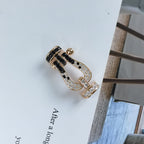 ??MIRA?¡¥FORCE LARGE HORSESHOE BLACK WHITE DIAMOND BRACELET SILVER